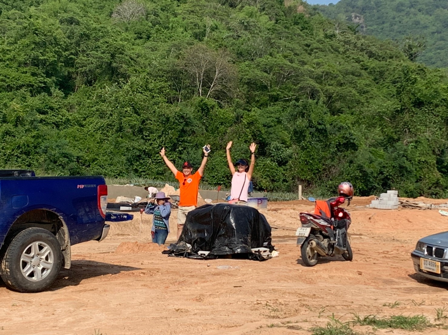 2 customer standing in font of the hillside